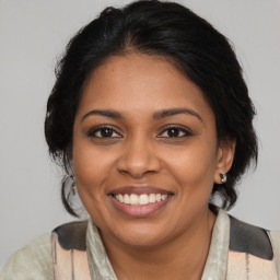 Joyful black young-adult female with medium  brown hair and brown eyes