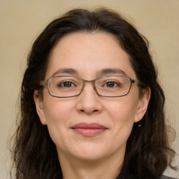 Joyful white adult female with long  brown hair and brown eyes