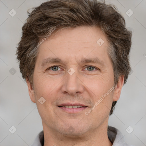 Joyful white adult male with short  brown hair and grey eyes