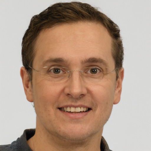 Joyful white adult male with short  brown hair and grey eyes