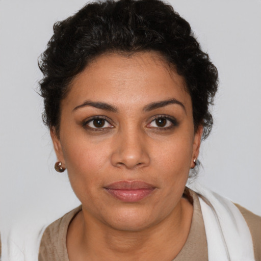 Joyful latino young-adult female with short  brown hair and brown eyes