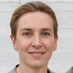 Joyful white adult female with short  brown hair and grey eyes