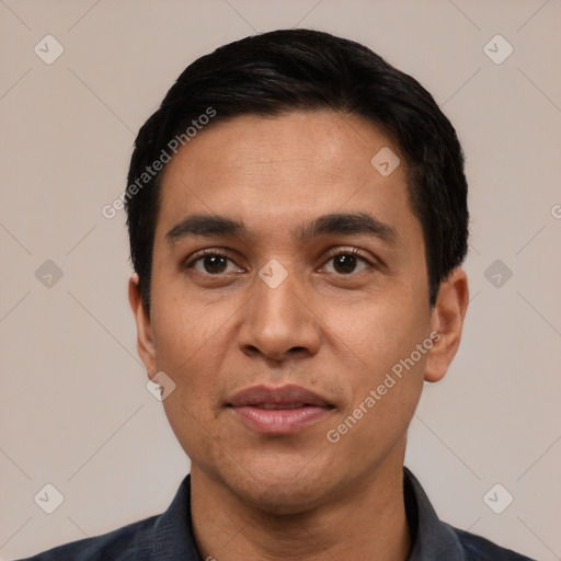 Joyful white adult male with short  black hair and brown eyes