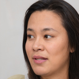 Joyful asian young-adult female with long  brown hair and brown eyes