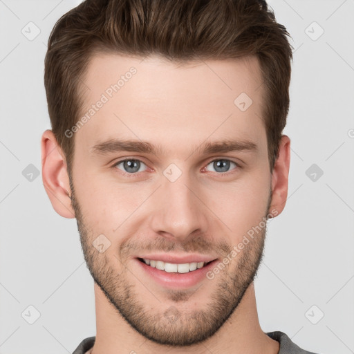 Joyful white young-adult male with short  brown hair and grey eyes