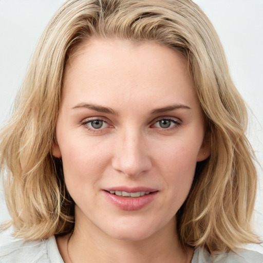 Joyful white young-adult female with medium  brown hair and blue eyes