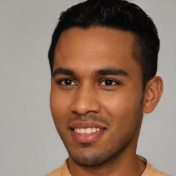 Joyful latino young-adult male with short  black hair and brown eyes