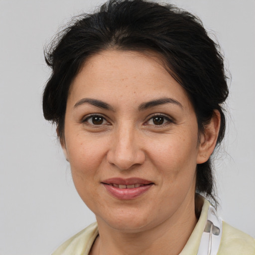 Joyful asian adult female with medium  brown hair and brown eyes