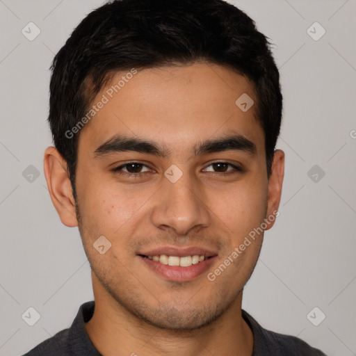 Joyful latino young-adult male with short  brown hair and brown eyes