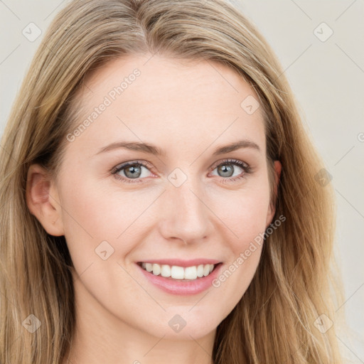 Joyful white young-adult female with long  brown hair and blue eyes