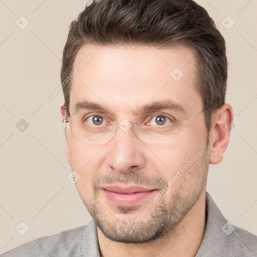 Joyful white adult male with short  brown hair and brown eyes