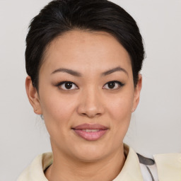 Joyful asian young-adult female with short  brown hair and brown eyes