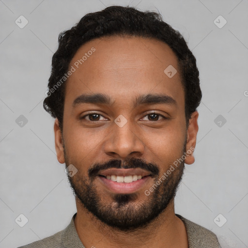 Joyful black young-adult male with short  black hair and brown eyes