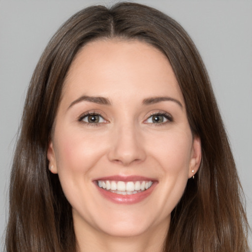 Joyful white young-adult female with long  brown hair and brown eyes