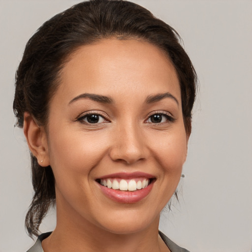 Joyful white young-adult female with medium  brown hair and brown eyes