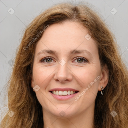 Joyful white young-adult female with long  brown hair and green eyes