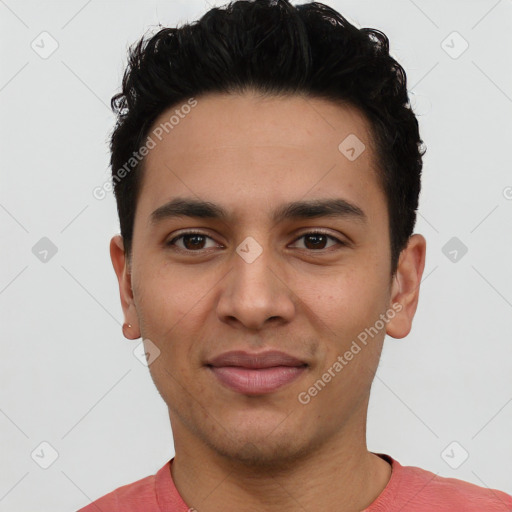 Joyful latino young-adult male with short  black hair and brown eyes