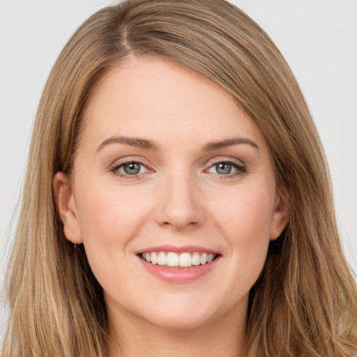 Joyful white young-adult female with long  brown hair and grey eyes