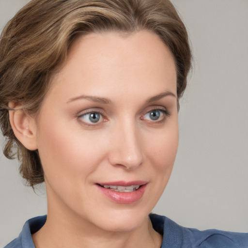 Joyful white young-adult female with medium  brown hair and blue eyes