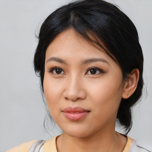 Joyful asian young-adult female with medium  black hair and brown eyes