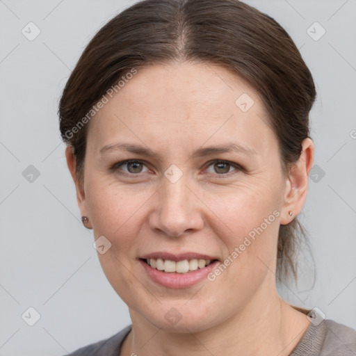 Joyful white adult female with medium  brown hair and grey eyes