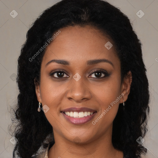 Joyful black young-adult female with long  brown hair and brown eyes