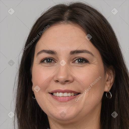 Joyful white adult female with long  brown hair and brown eyes