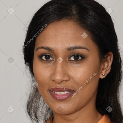 Joyful black young-adult female with long  brown hair and brown eyes