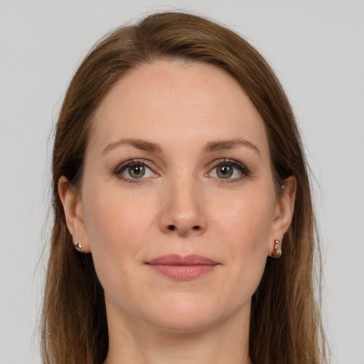 Joyful white young-adult female with long  brown hair and grey eyes