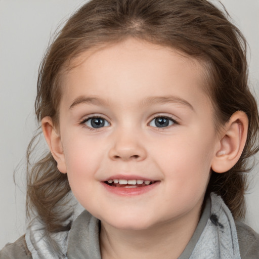 Joyful white child female with medium  brown hair and blue eyes