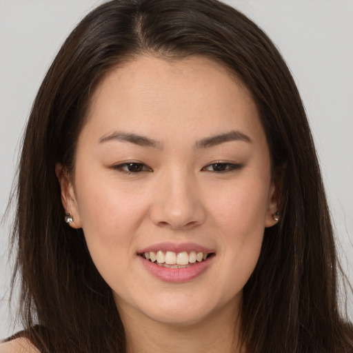 Joyful white young-adult female with long  brown hair and brown eyes