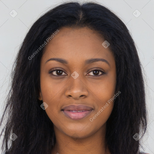 Joyful black young-adult female with long  brown hair and brown eyes