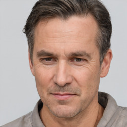 Joyful white middle-aged male with short  brown hair and brown eyes