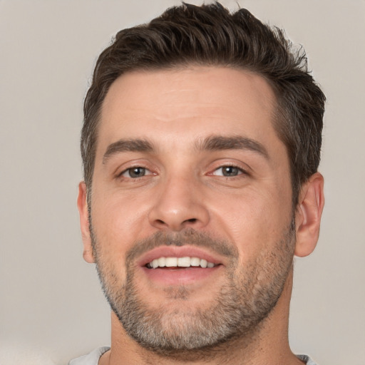 Joyful white adult male with short  brown hair and brown eyes