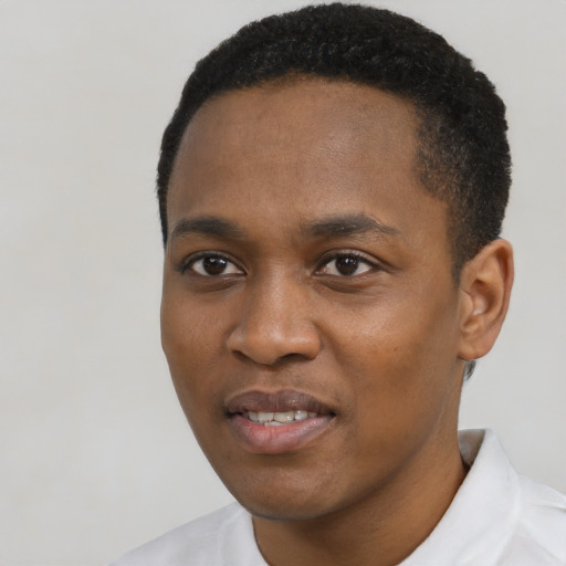 Joyful black young-adult male with short  black hair and brown eyes