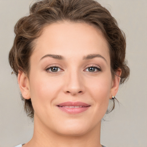 Joyful white young-adult female with medium  brown hair and green eyes