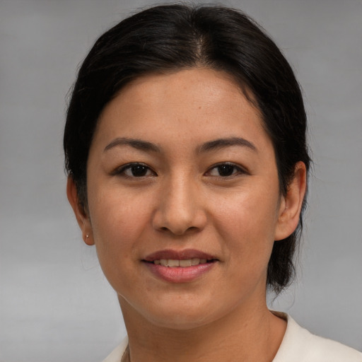 Joyful asian adult female with medium  brown hair and brown eyes
