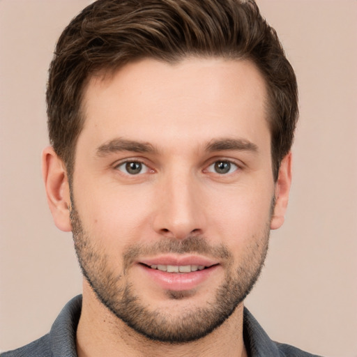 Joyful white young-adult male with short  brown hair and brown eyes