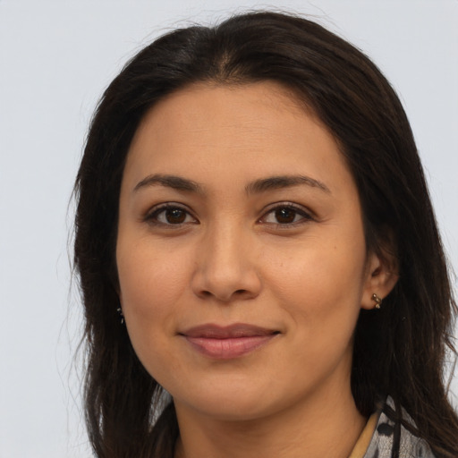 Joyful latino young-adult female with long  brown hair and brown eyes