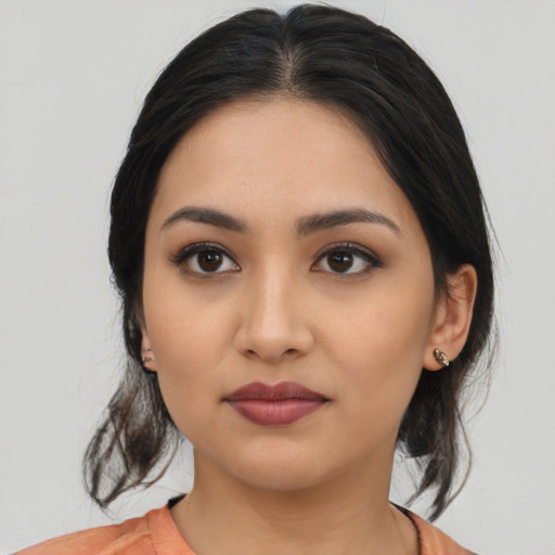 Joyful latino young-adult female with medium  black hair and brown eyes