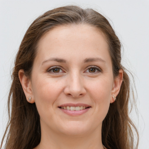 Joyful white young-adult female with long  brown hair and grey eyes