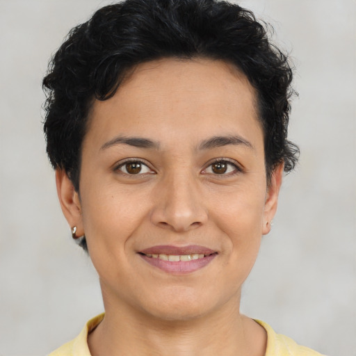Joyful latino young-adult female with short  brown hair and brown eyes