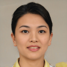 Joyful asian young-adult female with short  brown hair and brown eyes