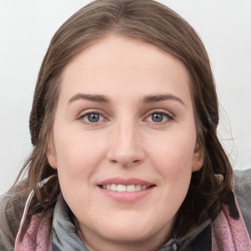 Joyful white young-adult female with medium  brown hair and grey eyes