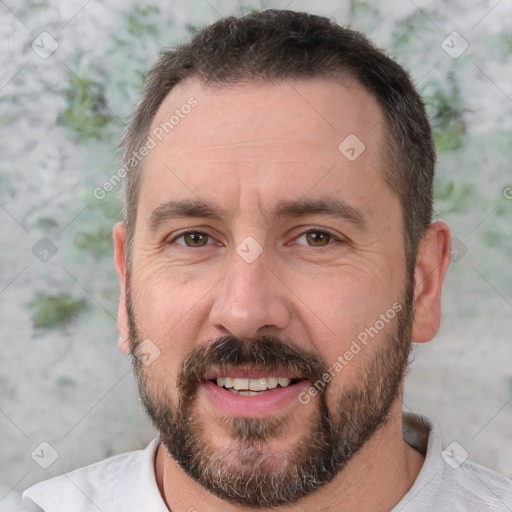 Joyful white adult male with short  brown hair and brown eyes