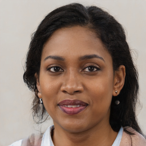Joyful black young-adult female with medium  brown hair and brown eyes