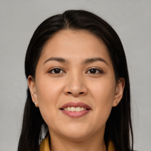 Joyful asian young-adult female with long  brown hair and brown eyes