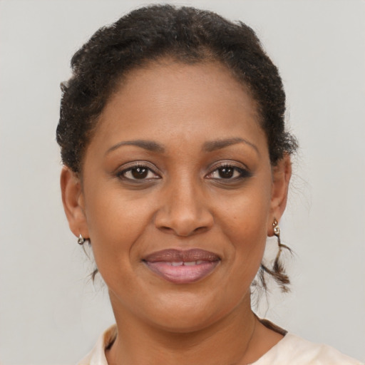 Joyful black adult female with short  brown hair and brown eyes