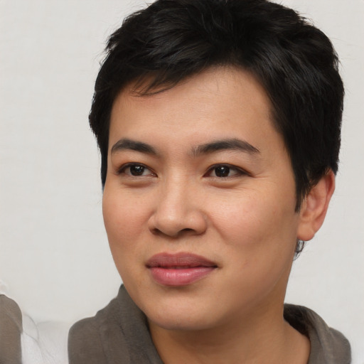 Joyful asian young-adult male with short  brown hair and brown eyes