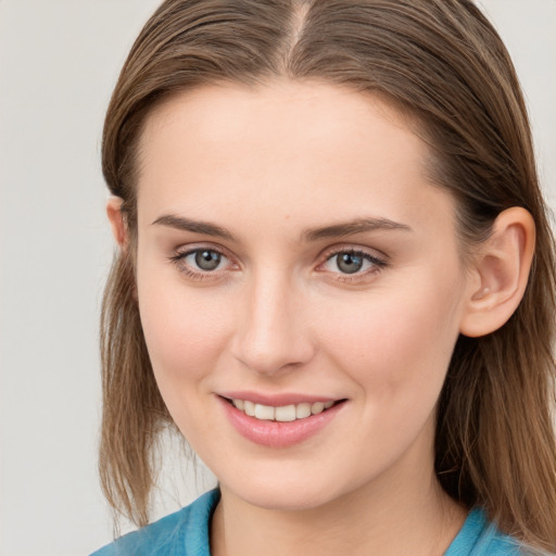 Joyful white young-adult female with medium  brown hair and blue eyes